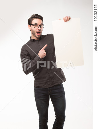 Young happy man showing presentation, pointing on Young happy man showing presentation, pointing on 30132165