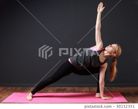 woman staying triangle pose woman staying triangle pose 30132351