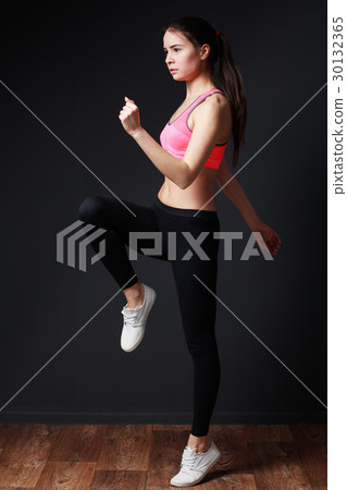 young energetic woman walks highly lifting 30132365