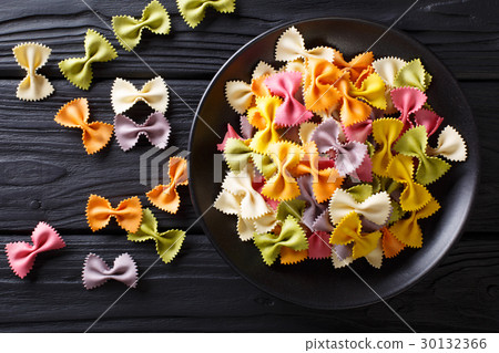 Beautiful Italian uncooked colored farfalle pasta Beautiful Italian uncooked colored farfalle pasta 30132366