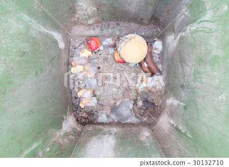 Decaying fruit in a dustbin 30132710