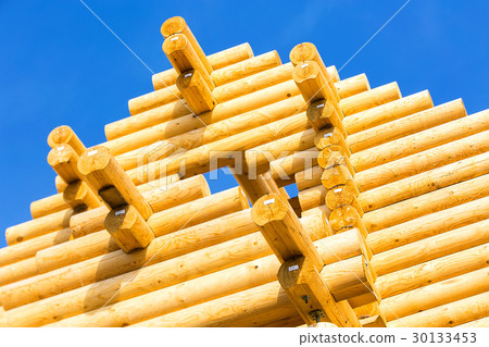 exterior frame of a log home under construction. 30133453
