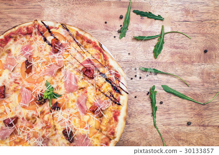 Pizza with dried tomatoes and prosciutto Pizza with dried tomatoes and prosciutto 30133857