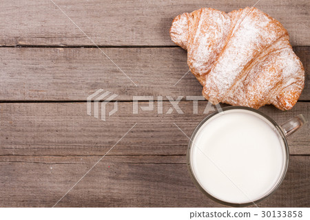 glass of milk with croissants on old wooden 30133858