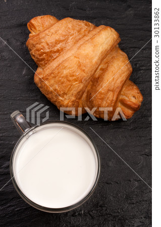 glass of milk with croissants on black stone glass of milk with croissants on black stone 30133862