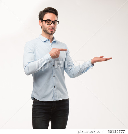 Young happy man showing presentation, pointing on Young happy man showing presentation, pointing on 30139777