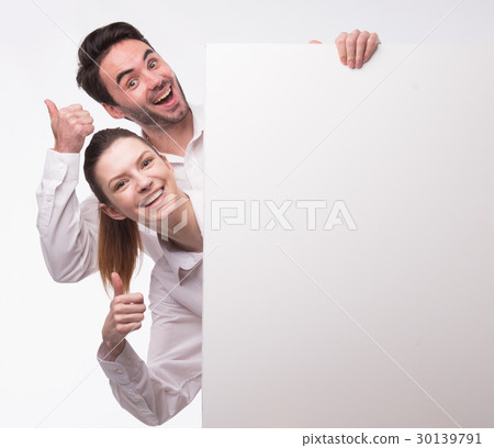 Young happy couple showing presentation pointing Young happy couple showing presentation pointing 30139791