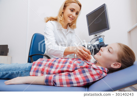 Optimistic young patient having ultrasound thyroid 30140243