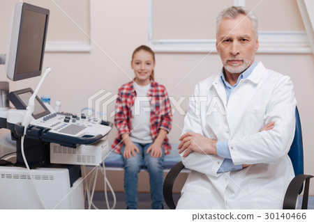 Confident aged doctor working in the clinic Confident aged doctor working in the clinic 30140466
