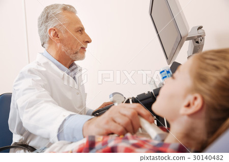 Aging physician making ultrasound monitoring in Aging physician making ultrasound monitoring in 30140482