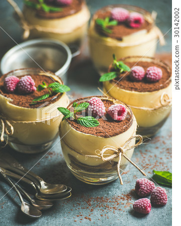 Homemade Tiramisu in glasses with mint leaves and Homemade Tiramisu in glasses with mint leaves and 30142002