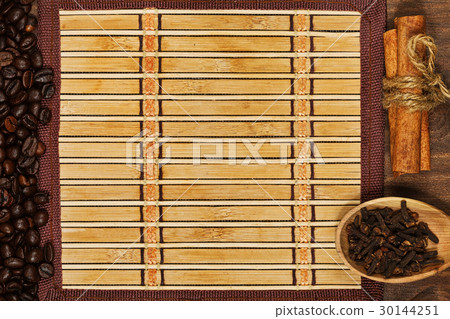 Bamboo mat framed of coffee beans and condiments Bamboo mat framed of coffee beans and condiments 30144251