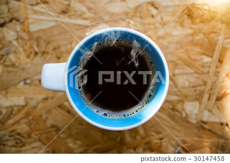 Hot coffee on wood with sunlight in the morning. 30147458