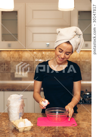 Cheerful smiling woman cooking in the kitchen 30147817