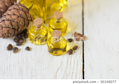 The cedar oil in a glass bottle 30148077