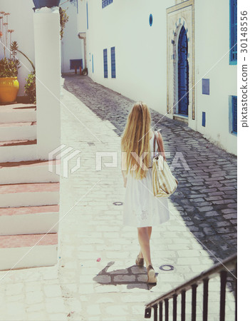Woman walking in Sidi Bou Said. La Gulett, Tunisia Woman walking in Sidi Bou Said. La Gulett, Tunisia 30148556