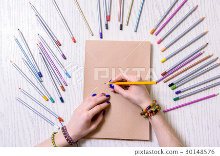 Young woman keeping orange pencil 30148576