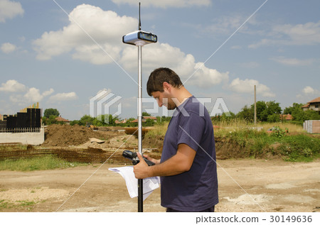 Geodesist working on a terrain 30149636