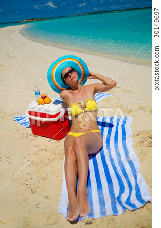 Beautiful lady resting alone on a beach 30149697