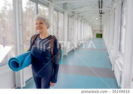 Happy retiree going in hall after training 30149816