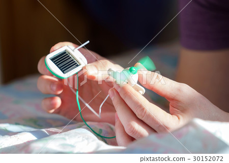 boy with solar panel windmill 30152072