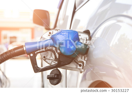 Fuel nozzle to refill fuel in car at gas station. Fuel nozzle to refill fuel in car at gas station. 30153227