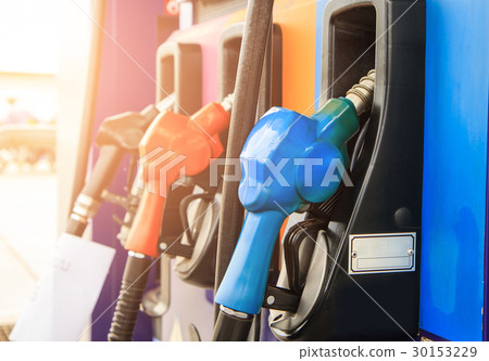 Fuel nozzle dispensing pump at gas station. Fuel nozzle dispensing pump at gas station. 30153229