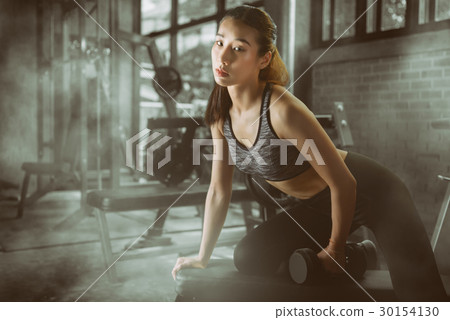 Young attractive sporty woman with dumbbells 30154130