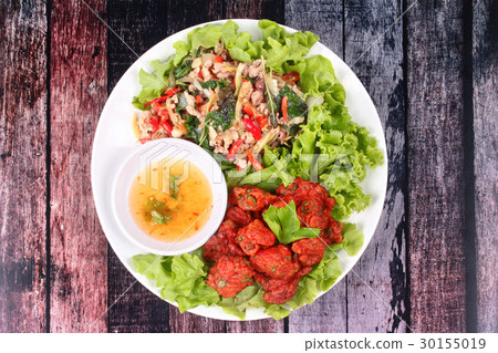 Fried spicy basil with pork and curried fish cake. 30155019