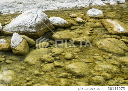 Rocky bottom of brook close-up as background. 30155075