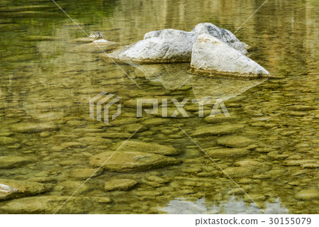 Rocky bottom of brook close-up as background. 30155079