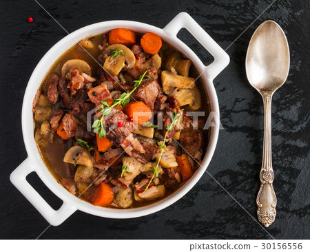 Beef Bourguignon in a casserole on black stone 30156556