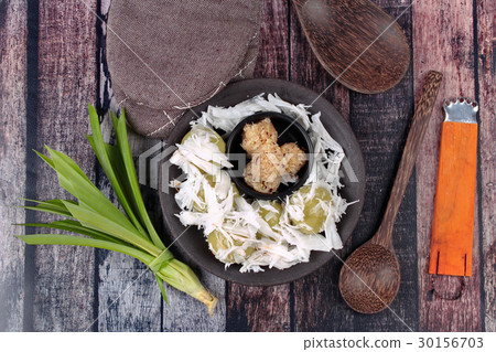 Steamed flour wrap sweet mashed coconut. 30156703