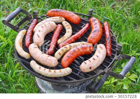 Grilled sausages on barbecue grill outdoor 30157228