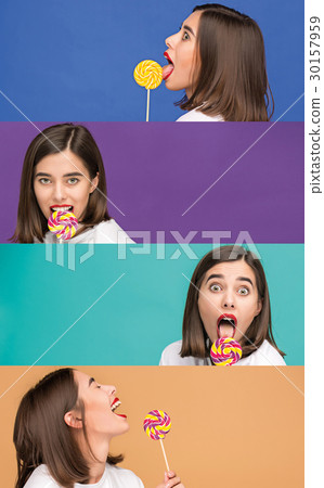 young woman with the colorful lollipop at studio young woman with the colorful lollipop at studio 30157959