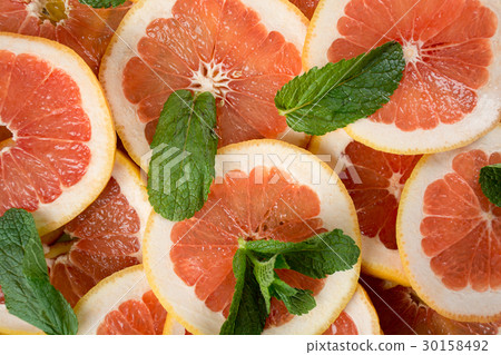 Pile of sliced grapefruit Pile of sliced grapefruit 30158492