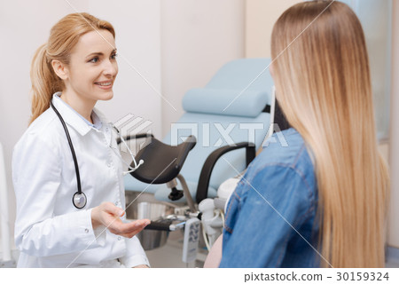 Helpful obstetrician consulting pregnant patient Helpful obstetrician consulting pregnant patient 30159324