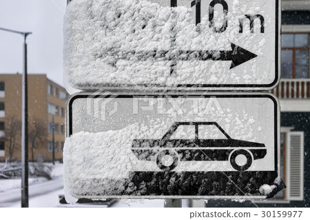 Road signs parking on the street under snow 30159977