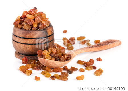 raisins in a wooden bowl with spoon isolated on 30160103