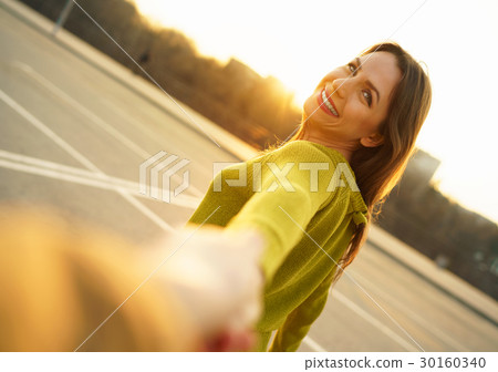 Follow me - happy young woman pulling guy's hand Follow me - happy young woman pulling guy's hand 30160340