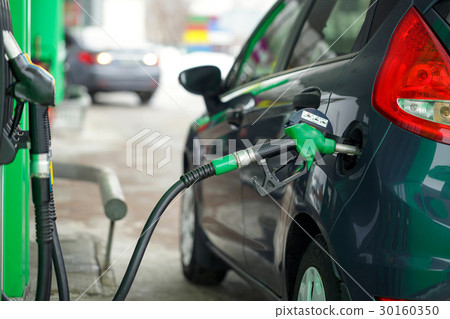 Car refueling on a petrol station in winter Car refueling on a petrol station in winter 30160350