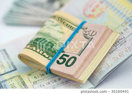 American money is on the top of the passport American money is on the top of the passport 30160491