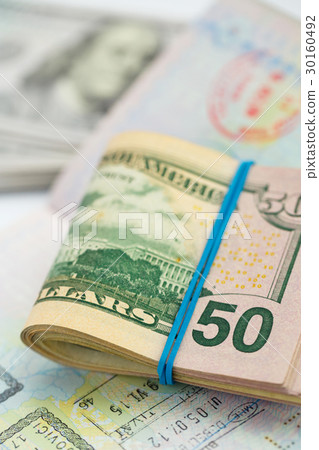 American money is on the top of the passport American money is on the top of the passport 30160492