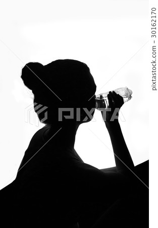 Silhouette of woman drinking bottled water 30162170