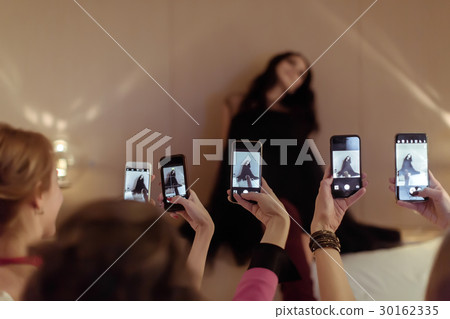 Women taking shots of friend 30162335