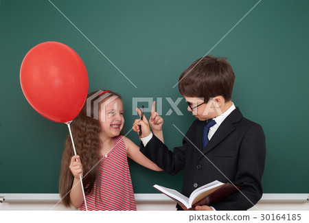 boy and girl near school board  30164185