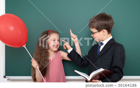 boy and girl near school board  30164186