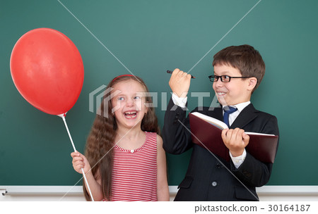 boy and girl near school board  30164187
