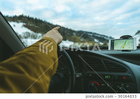Driver's hands on a steering wheel point straight Driver's hands on a steering wheel point straight 30164833