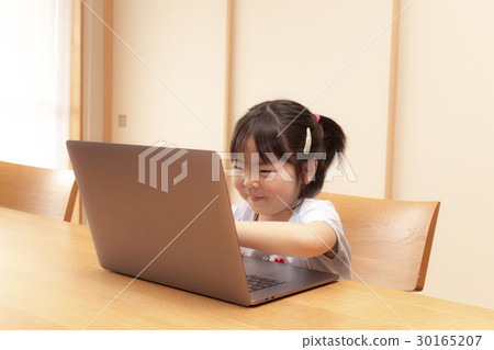 A girl headed to a computer 30165207